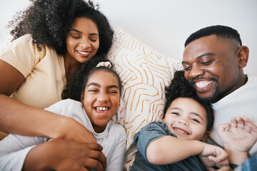 Mom, dad and kids in bed with tickling, comic joke and laugh with bonding, care and love in family home. Black man, mother and daughter with smile, playful game and crazy in bedroom, morning or house