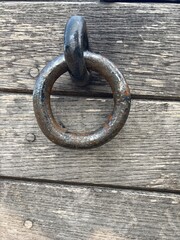 A black metal ring on a wooden wall