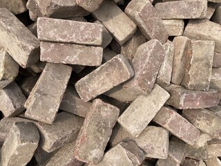 A piled heap of gray bricks