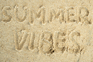 summer vibes drawn on beach sand