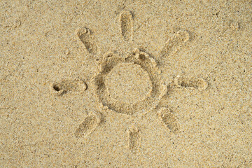 Fototapeta na wymiar Beach sand texture with sun drawn