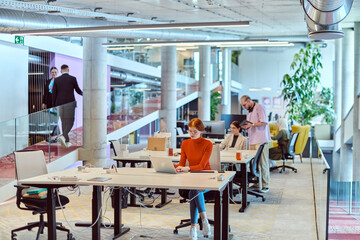 In a modern startup office, a diverse group of young professionals collaboratively tackles various business problems and challenges, surrounded by their engaged colleagues, fostering innovation and
