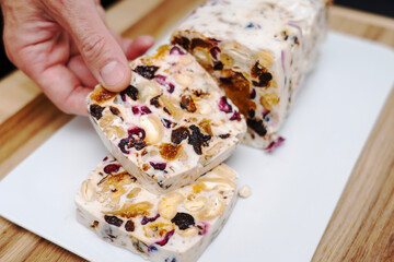 Milky nut jelly dessert, a man's hand holding a slice. 