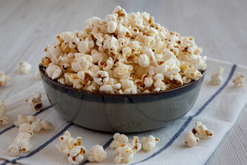 Homemade Buttered Popcorn with Salt in a Bowl, side view. Close-up.