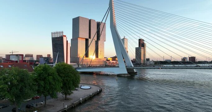 Aerial drone view of the Erasmusbrug in Rotterdam during golden hour.