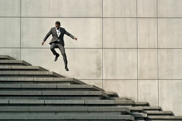 businessman walking up stairs in office building