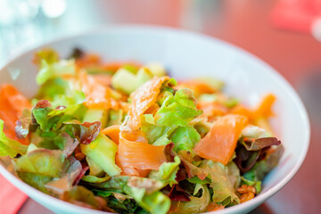 Smoked salmon salad with lettuce, walnuts and avocado, healthy food concept
