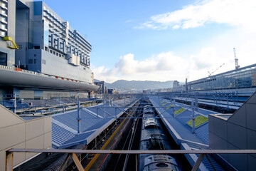 the grandeur of Kyoto Station, where a captivating row of roofs stretches along the train platform. 