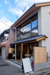 Immerse yourself in the serene ambiance of a Japanese-inspired coffee shop with this captivating mock-up of a typical stand and building