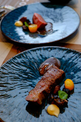 Australian Striploin Steak: Well done, and blur steak in background