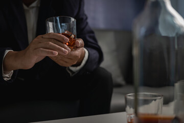 alcoholism alcohol addiction and people's ideas Alcoholic man with flask and drinking whiskey at home, businessman in luxury suit with glass of whiskey Elegant drink concept