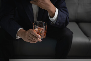 alcoholism alcohol addiction and people's ideas Alcoholic man with flask and drinking whiskey at home, businessman in luxury suit with glass of whiskey Elegant drink concept