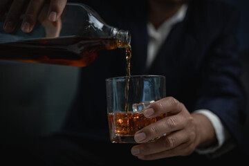 alcoholism alcohol addiction and people's ideas Alcoholic man with flask and drinking whiskey at home, businessman in luxury suit with glass of whiskey Elegant drink concept