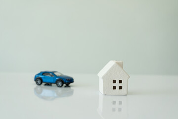 Car and house models, white background, insurance concept or real estate loan or property...
