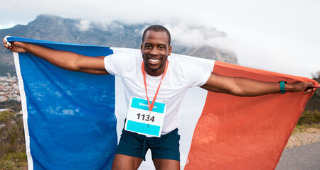 Fototapeta premium Runner man, flag and winner in portrait, pride and celebration for marathon, fitness and sports in street. Black guy, athlete and fabric for national sign, success or achievement at race in Cape Town