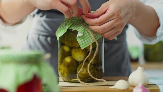 Garlic, woman of European appearance Cooking vegetables using marinade and brine in home kitchen housewife cook combines ingredients takes advantage of home cooking, fermented vegetables