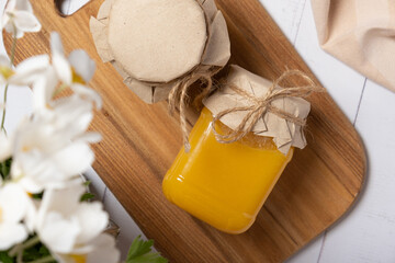 Jars with honey on wooden background top view, flat lay