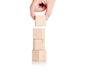 Obraz premium wooden cubes with hand on isolate white background