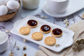 process of assembling tapas and cornstarch alfajores with dulce de leche and coconut with milk eggs sugar everything with white bajilla