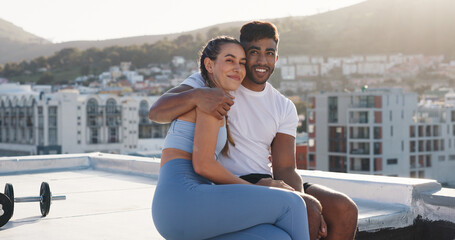 Fitness, couple for hug during exercise, workout or training together in the urban city. Happy woman, man and care in a conversation, communication or talking after cardio break on a rooftop