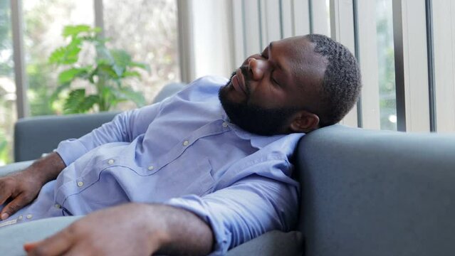 African American man sleeping on the sofa in the house. restful sleep