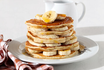 Fototapeta na wymiar Pile of banana pancakes with honey