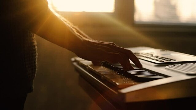 playing an electronic synthesizer piano at sunset in the evening. Music training
