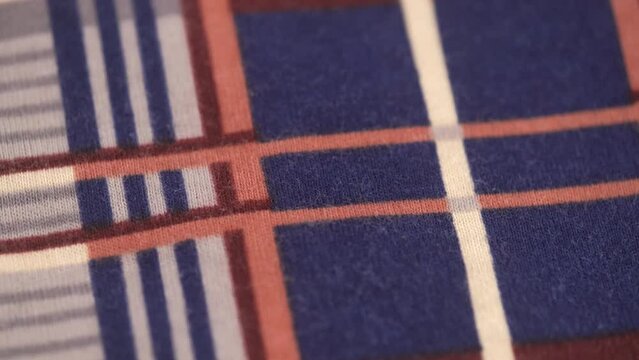 macro shooting of soft knitted fabric. rotation. closeup of a soft flannel fabric with a checkered stripe pattern.