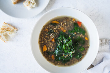 Lentil soup with beet greens, healthy summer vegan meal viewed from above