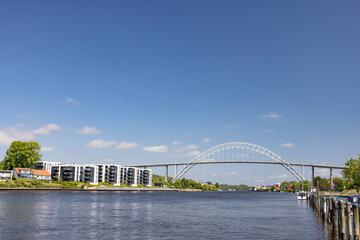Bridge over the river Glomma- Happy walking in  Fredrikstad city on a great warm summer day, with many old buildings, Norway	