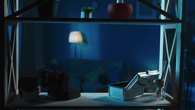 Video with a frame capturing the room from the shelf. There are empty boxes used for jewelry and valuables. Burglary scene. The camera is moving to the side slowly.