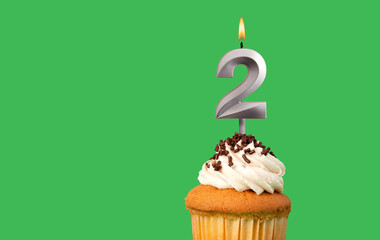 Birthday card with candle number 2 - Cupcake on green background