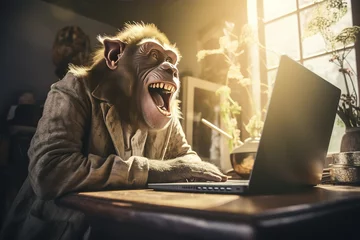 Foto op Plexiglas The monkey is sitting at his laptop and laughing. © BetterPhoto