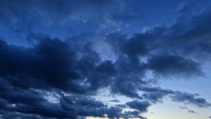 Naklejka na ściany i meble pretty huge bright clouds in the blue sky bg - photo of nature