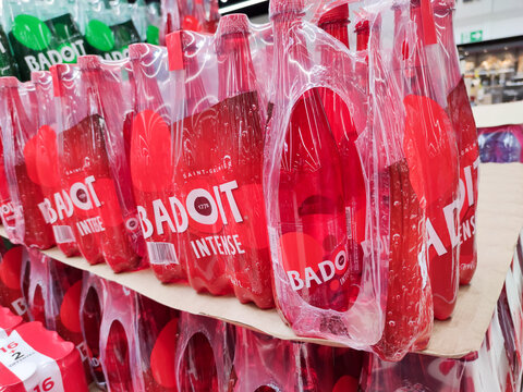 Closeup on packs of sparkling water "Badoit" brand. French watter on supermarket