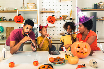 Family has fun in Halloween time make video call with digital tablet.