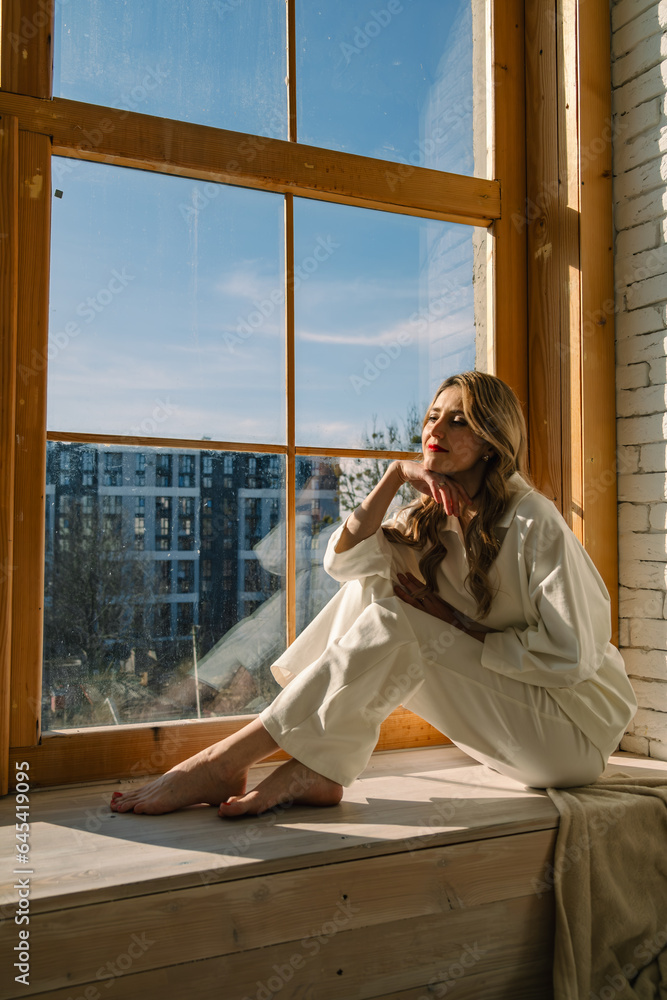 Canvas Prints beautiful woman near window highlighted with bright sun