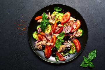 Tuna salad with cucumber and tomato. Top view with copy space.