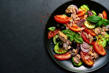 Tuna salad with cucumber and tomato. Top view with copy space.