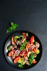 Tuna salad with cucumber and tomato. Top view with copy space.