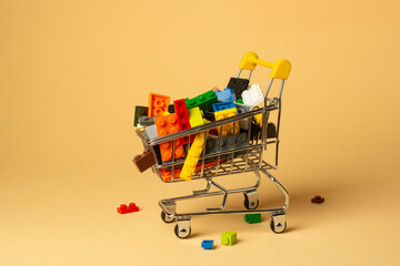 Multi-colored plastic children's construction blocks on a shopping cart.