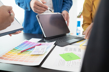 team of UI UX web designer are working together to develop mobile responsive websites with UI UX...