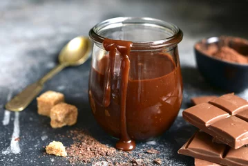 Foto op Canvas Homemade delicious chocolate caramel sauce in a vintage glass jar . © lilechka75