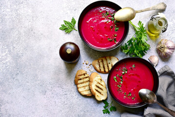 Delicious beetroot soup in a black bowls .  Top view with copy space.