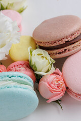 Beautiful Set colorful French macaroons and flowers. Flat lay, top view, white background. Concept gift for Valentines and mother day