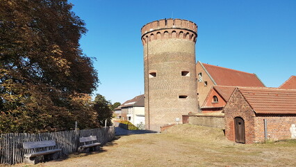 Adjacent to the building stands a towering structure constructed entirely of bricks, commanding...