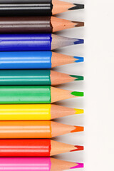 Colored pencils individually on a white background. Close-up.