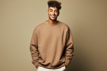 Obraz premium Isolated Portrait of a Fictional Male Model Wearing a Large Oversized Brown Colored Sweatshirt on a Plain Blank Background. Generative AI.