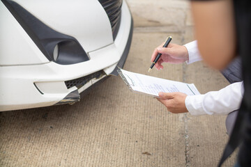 Insurance agents meet with customers when accidents occur to inspect damage and document insurance claims expeditiously. concept of car insurance agents to urgently inspect damage for customers.