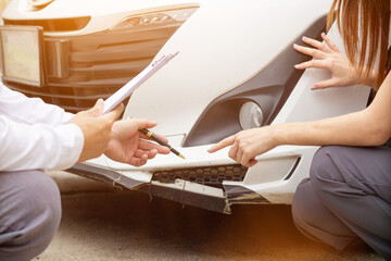 Insurance agents meet with customers when accidents occur to inspect damage and document insurance claims expeditiously. concept of car insurance agents to urgently inspect damage for customers.